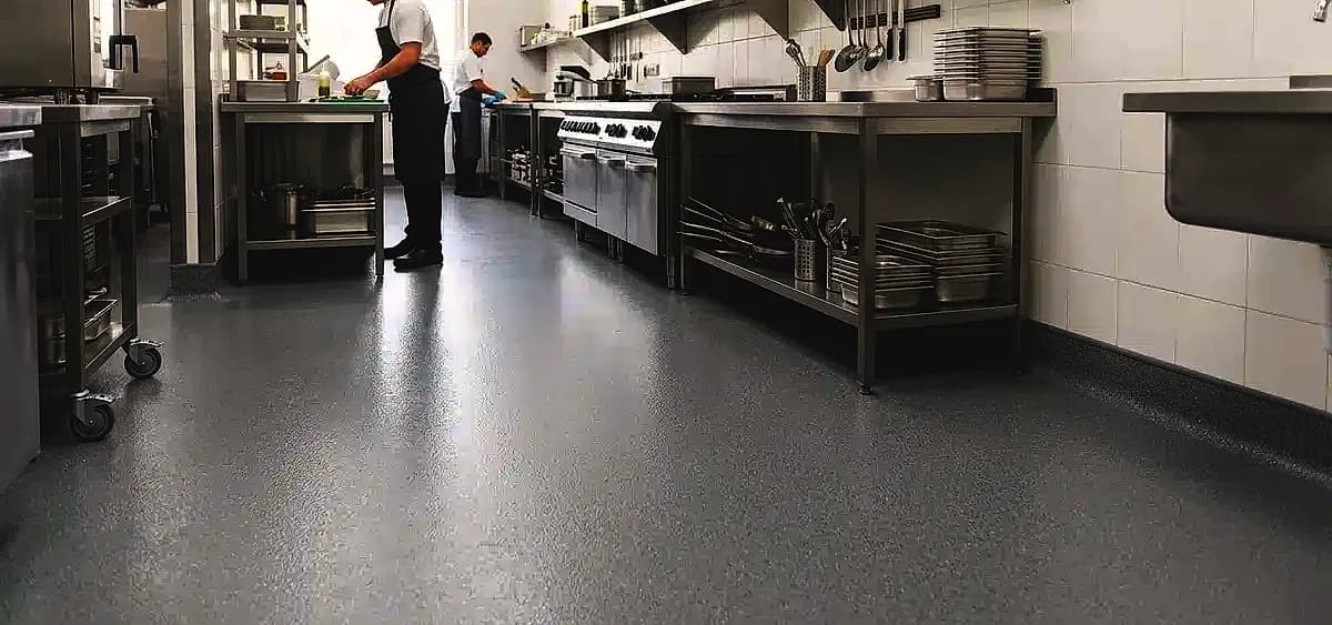 Commercial kitchen floor in Miami-Dade featuring seamless epoxy coating and proper 4-inch wall coving