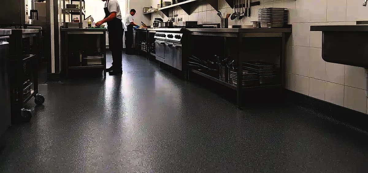 Commercial kitchen floor in Miami-Dade featuring seamless epoxy coating and proper 4-inch wall coving