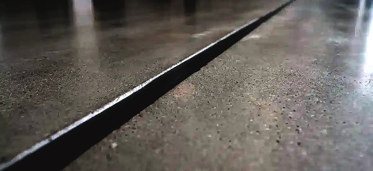 Close-up of a perfectly filled and coated concrete control joint demonstrating seamless flexibility