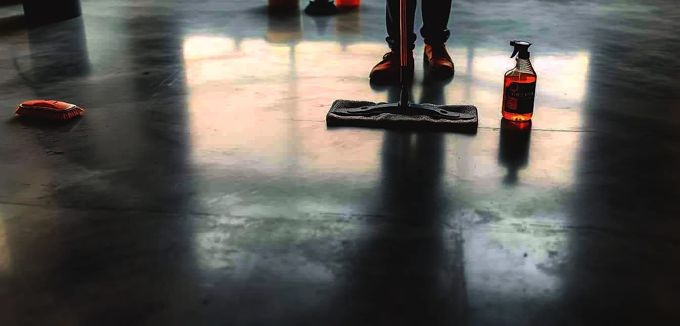 A well-lit, high-resolution image of a pristine concrete floor undergoing maintenance.