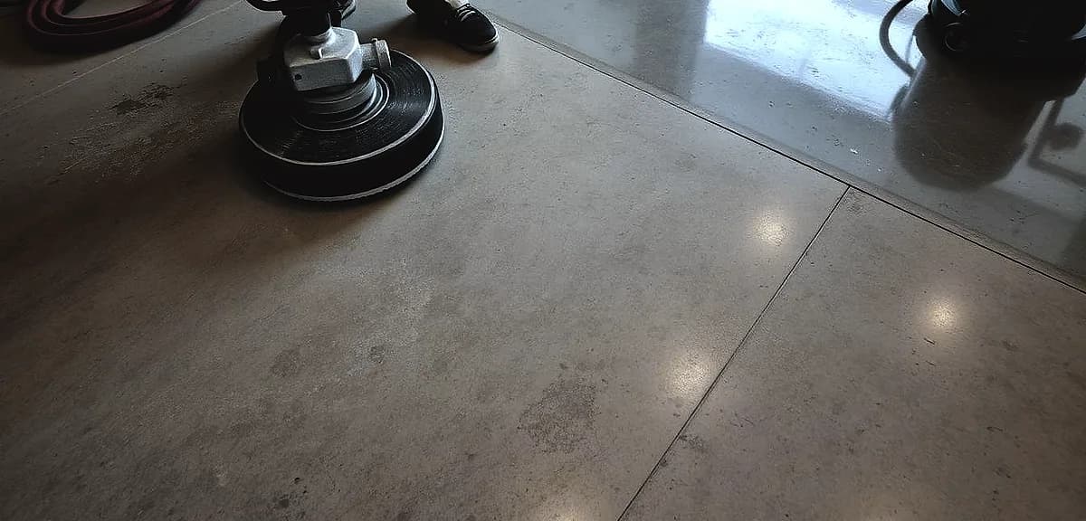 A well-lit, high-angle view of a concrete surface, showcasing the process of concrete polishing.