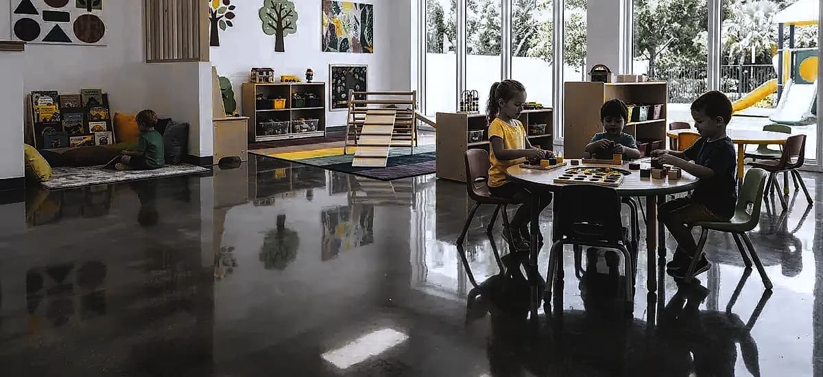 Brightly lit Pompano Beach daycare center featuring highly reflective polished concrete floors and colorful play areas