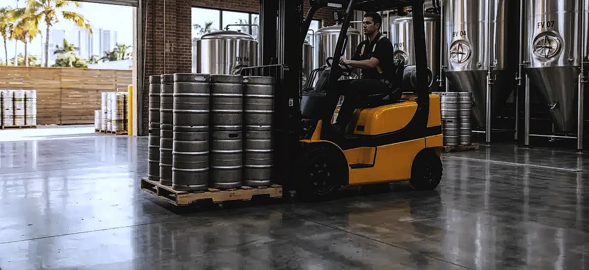 Forklift moving kegs on a durable polished concrete brewery floor in Fort Lauderdale