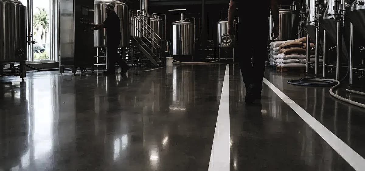 Seamless polished concrete floor in a Miami craft brewery production area meeting USDA standards