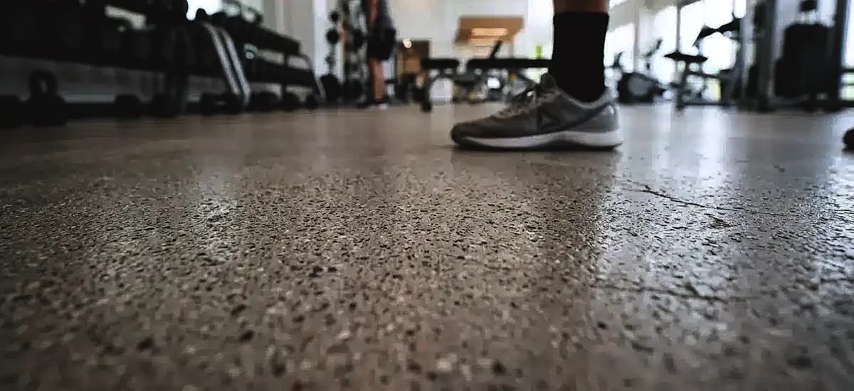 Close-up of micro-textured slip-resistant polished concrete surface in a modern Pompano Beach fitness center