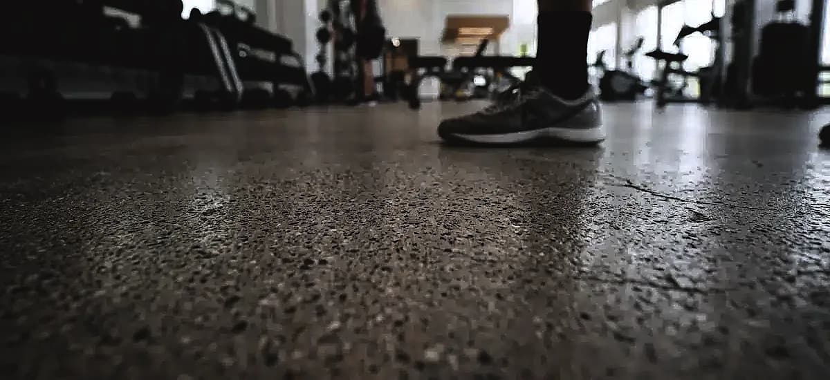 Close-up of micro-textured slip-resistant polished concrete surface in a modern Pompano Beach fitness center