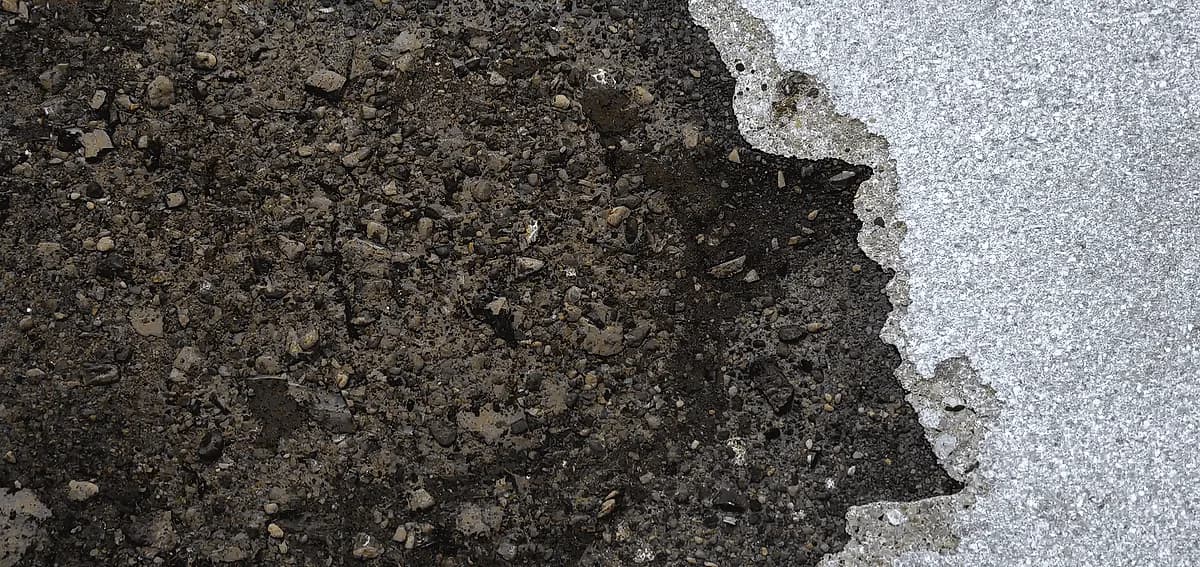 Dark oil stain on textured concrete, requiring professional concrete polishing South Florida cleaning and restoration.