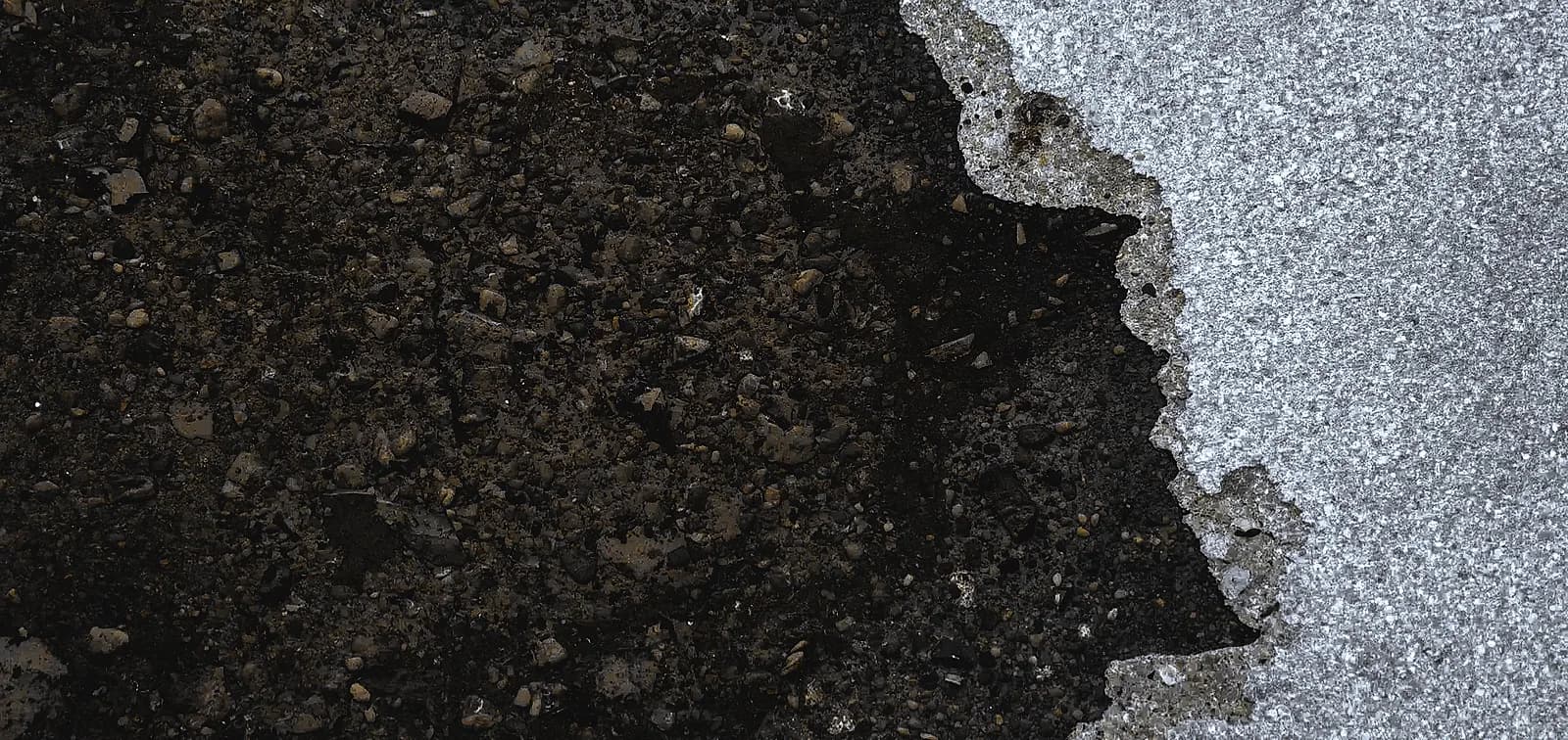 Dark oil stain on textured concrete, requiring professional concrete polishing South Florida cleaning and restoration.