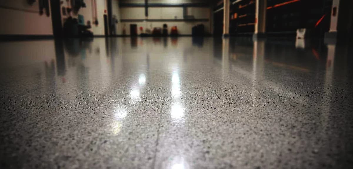 A glossy, well-lit epoxy floor in a pristine industrial setting.