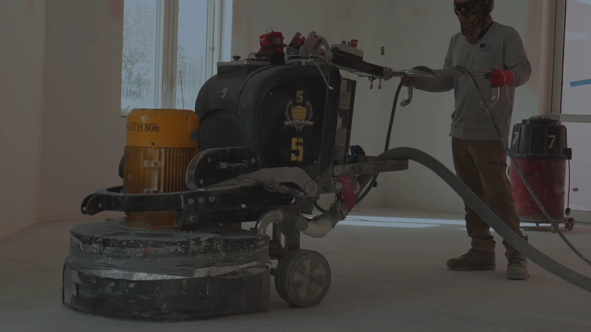 A floor grinder working across a concrete slab
