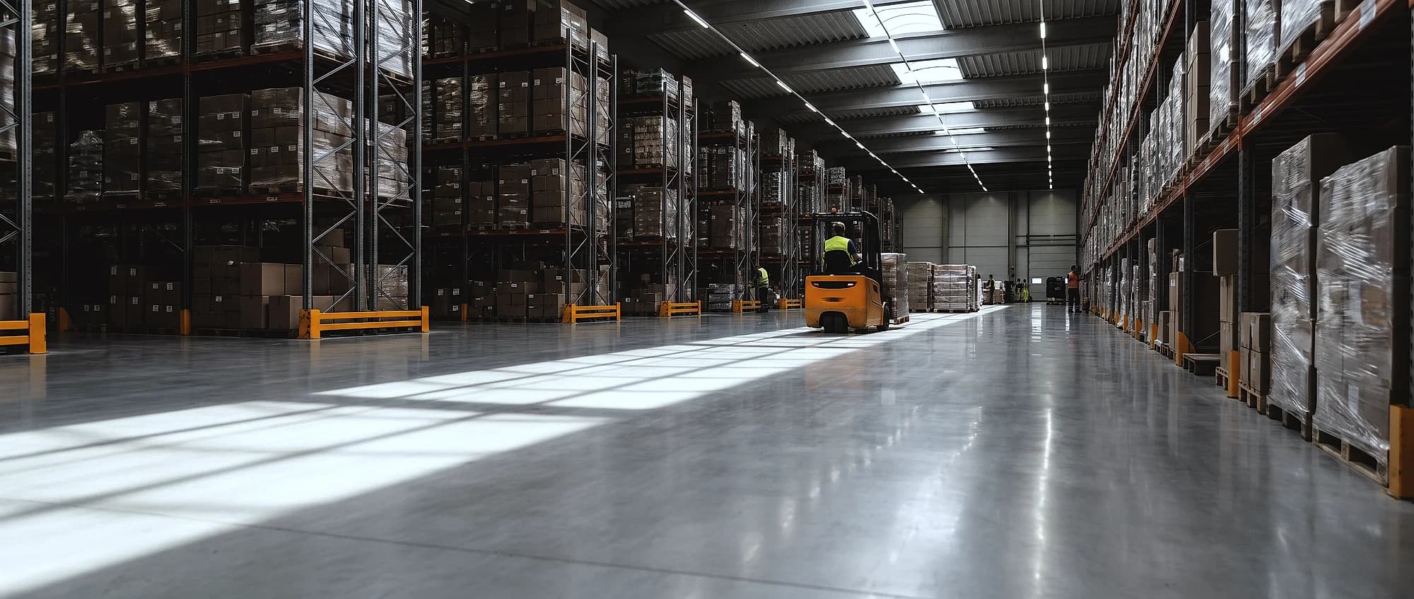 A polished concrete floor running down a racking aisle in a distribution warehouse