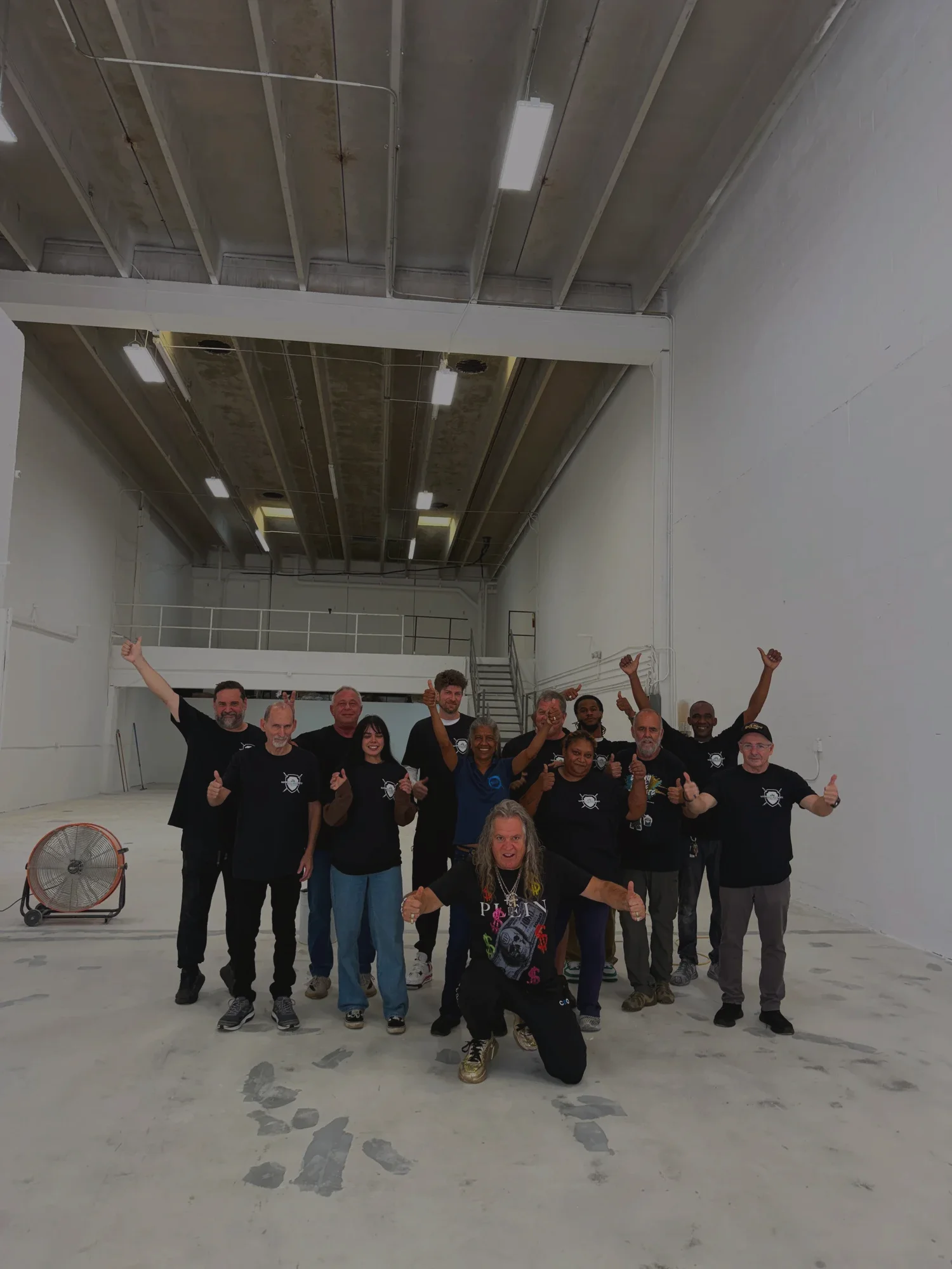 The National Concrete Polishing crew standing together on a finished warehouse floor
