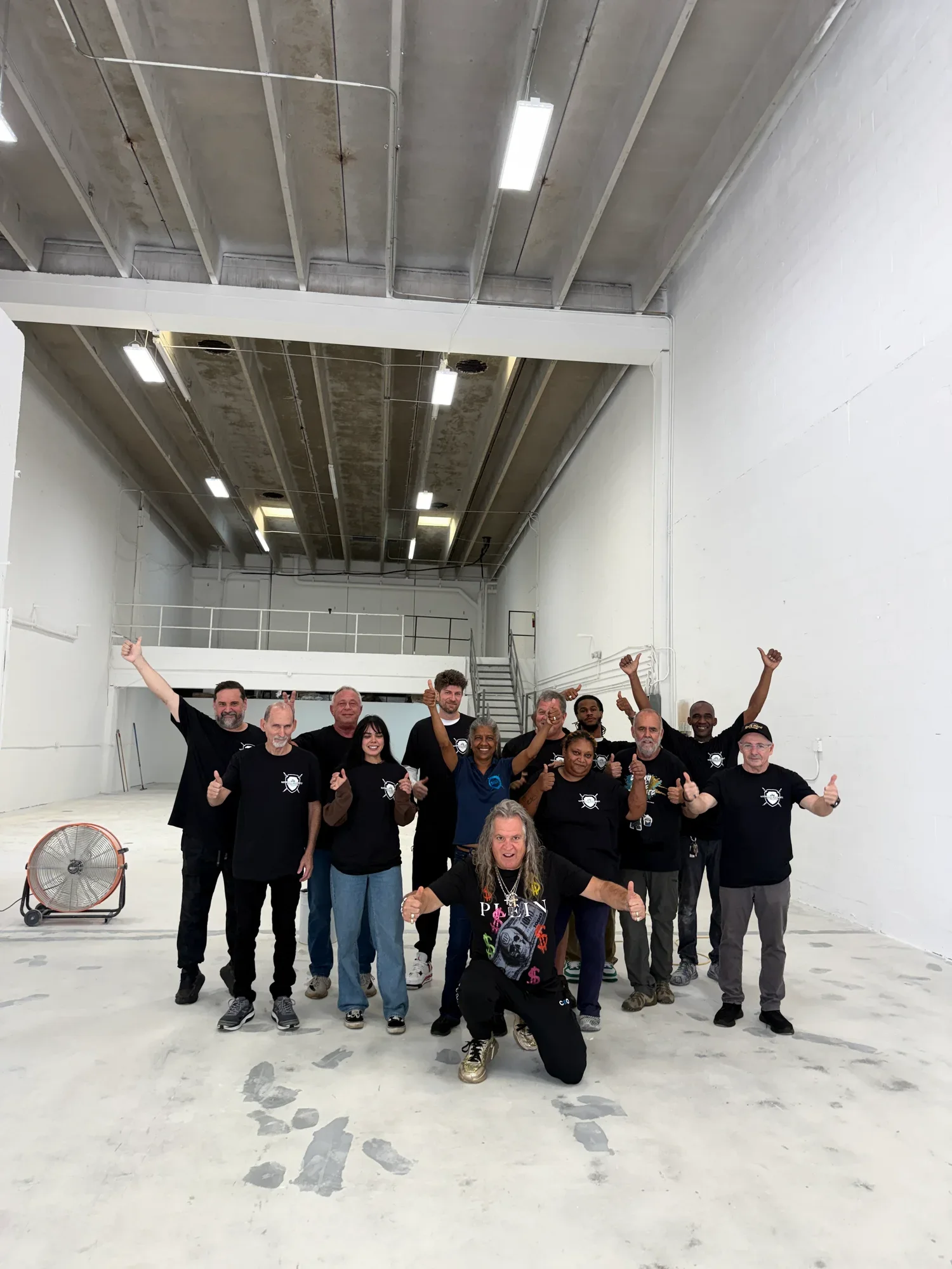 The National Concrete Polishing crew standing together on a finished warehouse floor