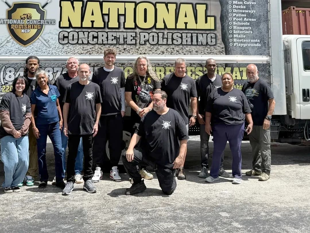 The crew standing in front of the National Concrete Polishing box truck outside the warehouse
