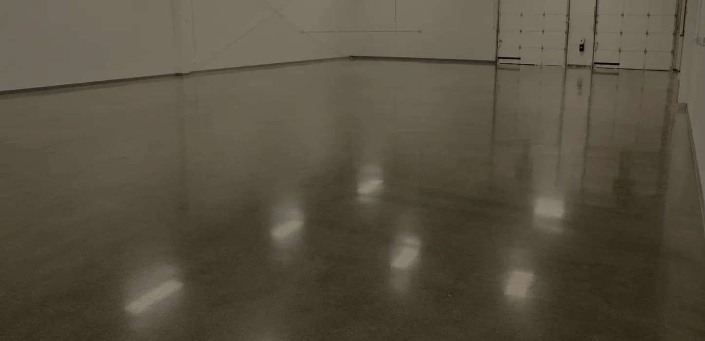 Polished concrete floor running the length of an empty warehouse bay