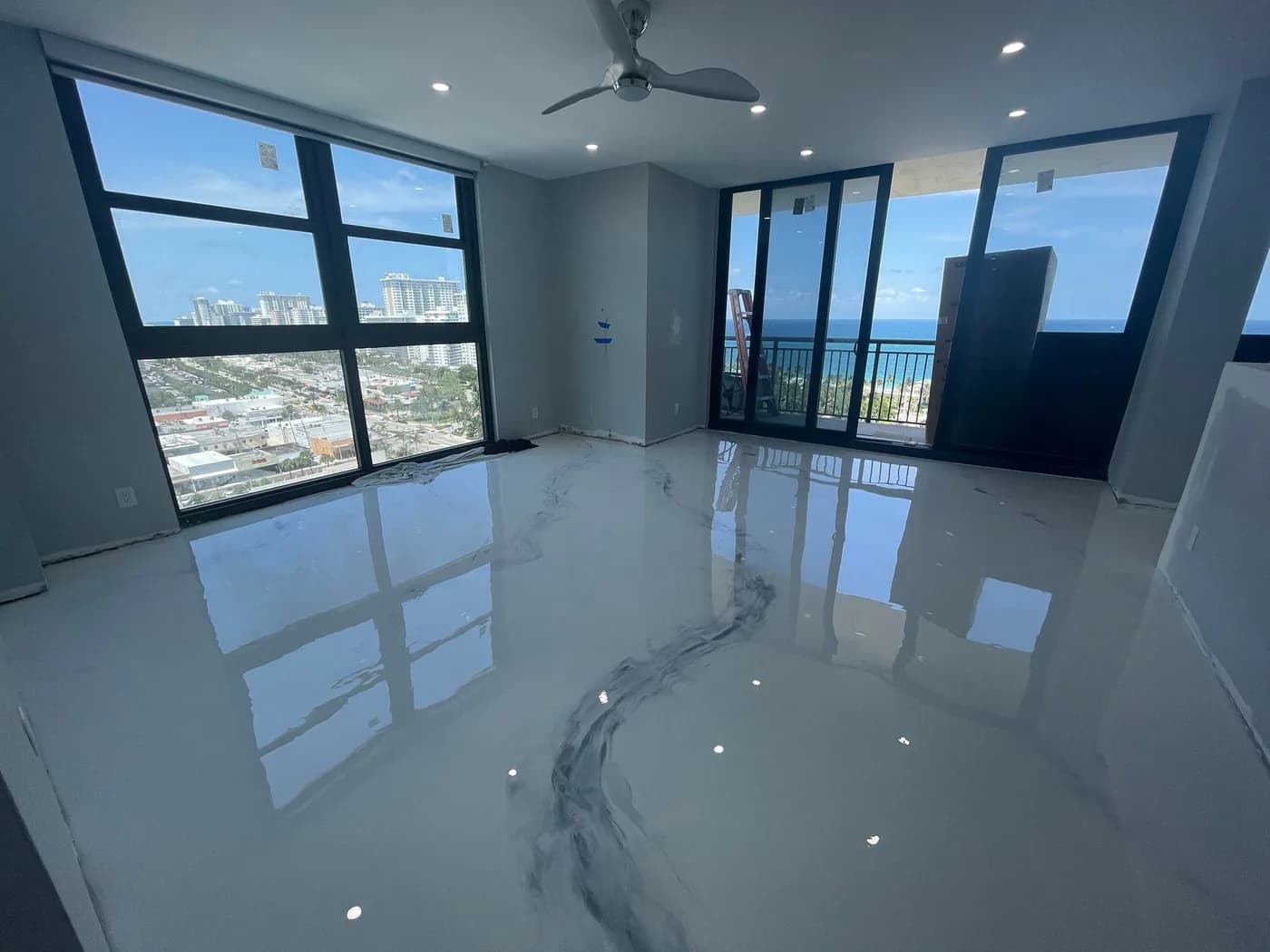 High-rise condo with a white marble metallic epoxy floor and ocean views