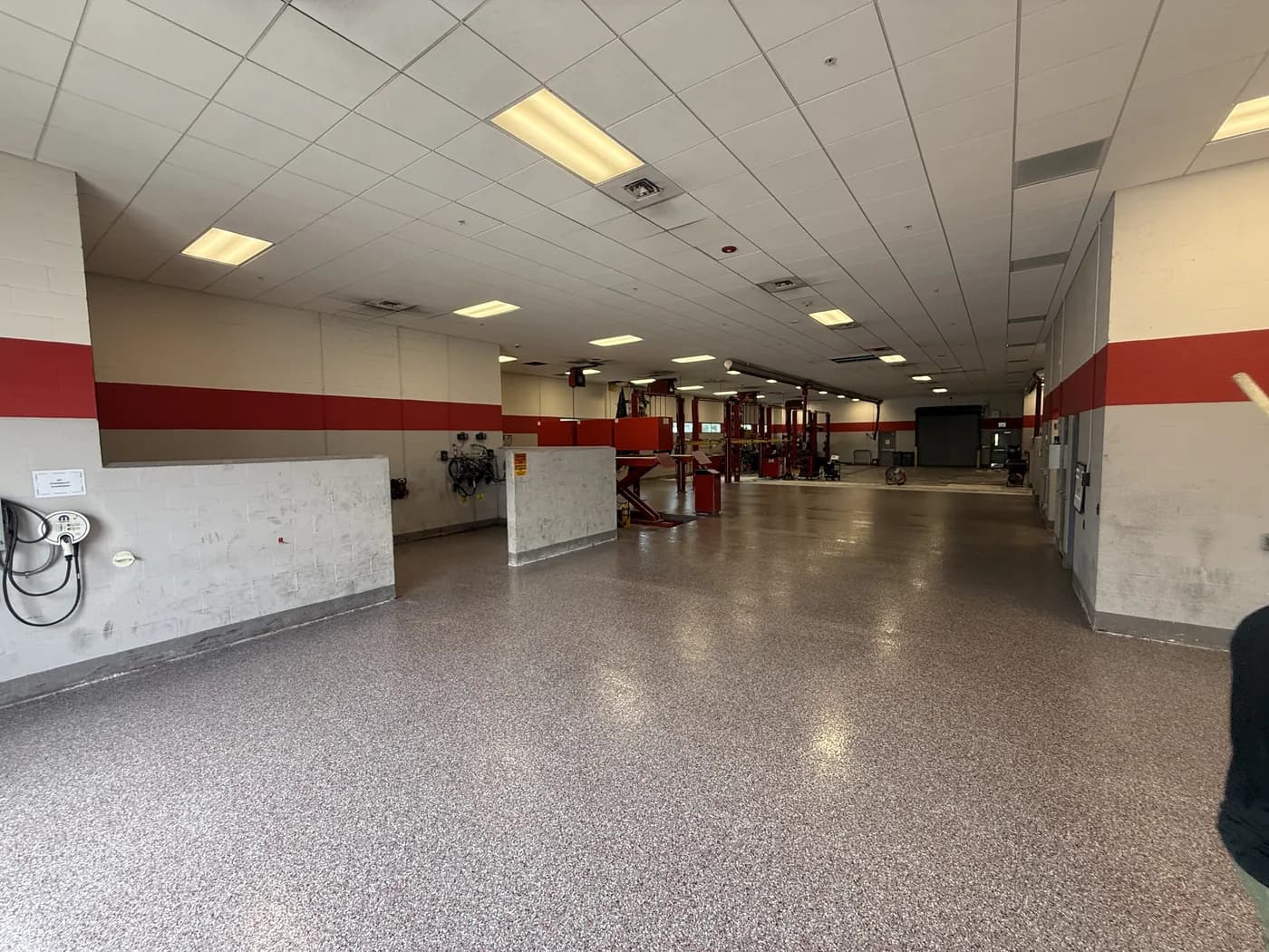 Flake epoxy floor running the length of a dealership service department
