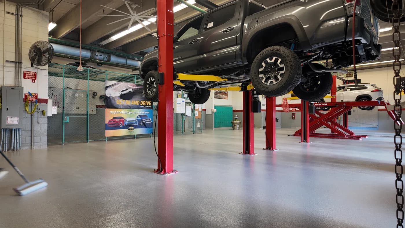 Pickup truck on a lift over a quartz epoxy shop floor