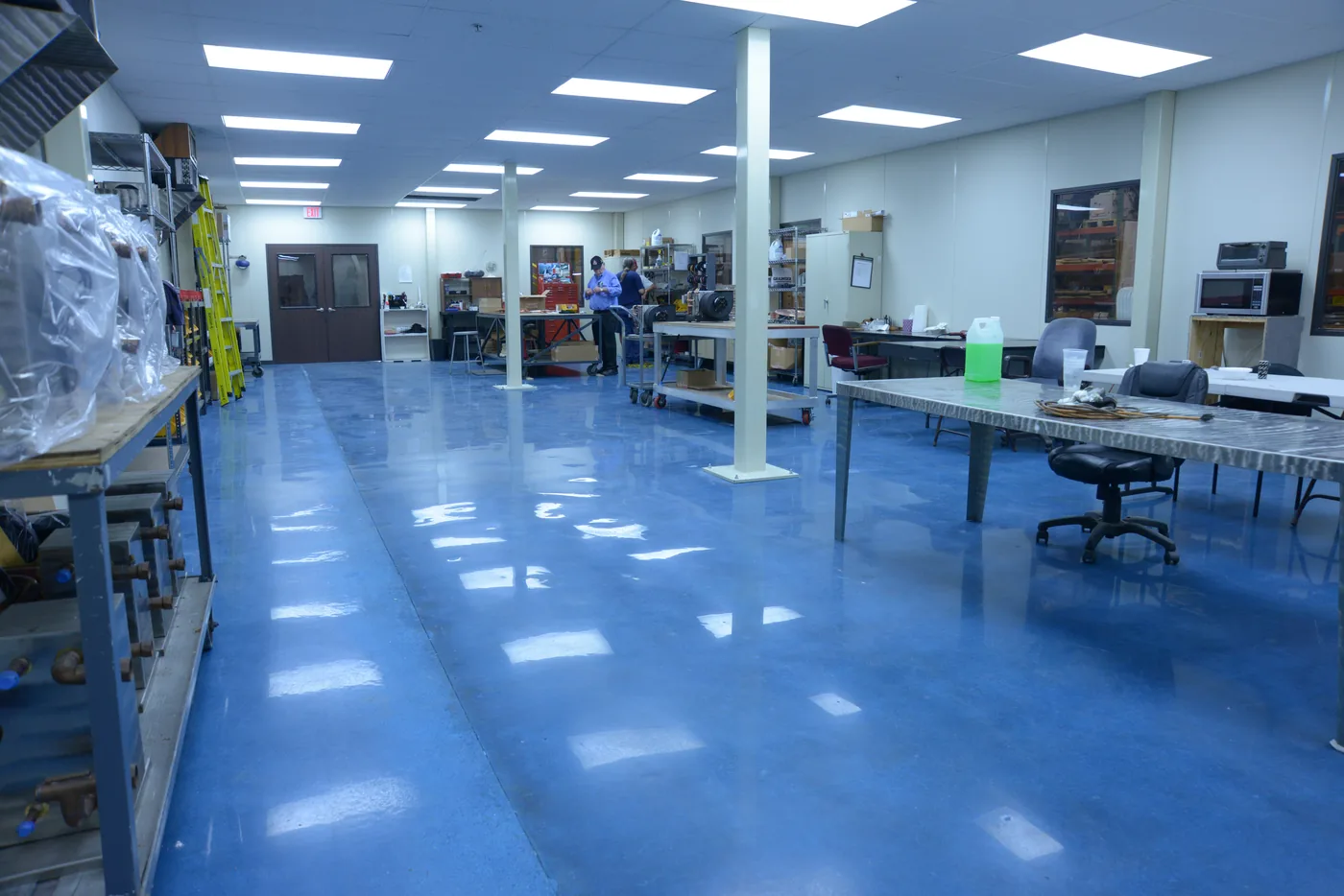 Blue epoxy floor in a workshop and office space