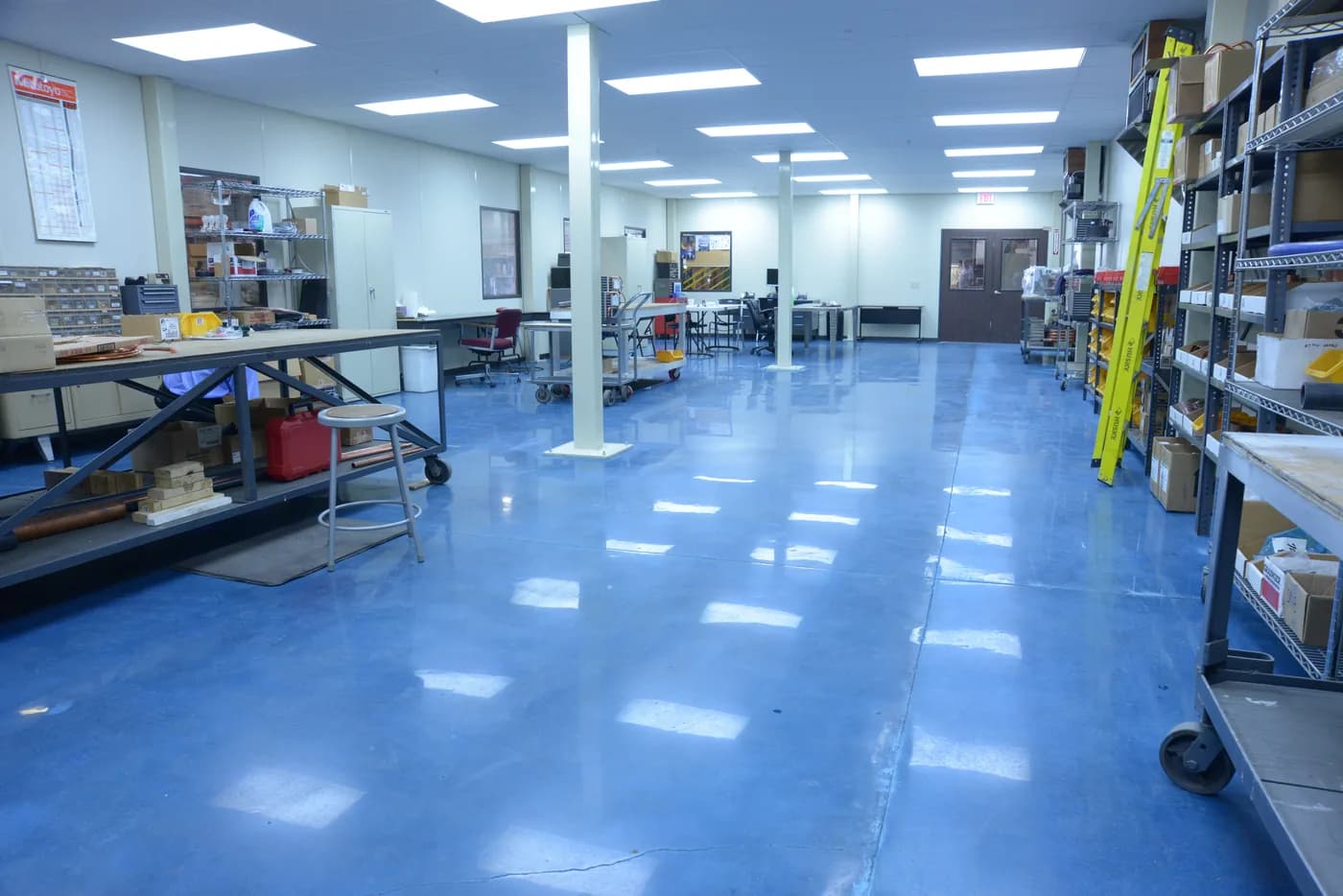 Blue epoxy floor in an open office and workshop
