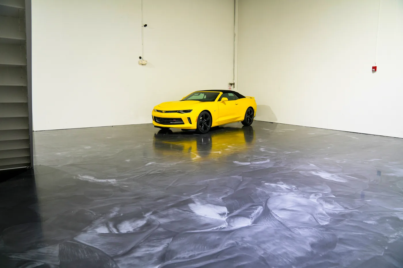 Gray metallic epoxy floor in an open showroom