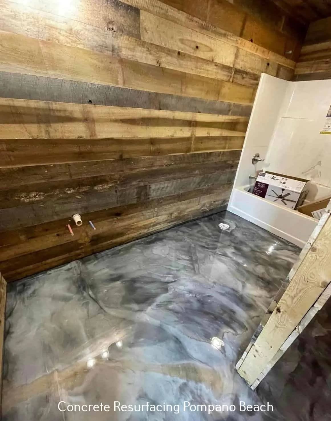 A silver-grey metallic floor laid up to the skirting against a reclaimed timber wall