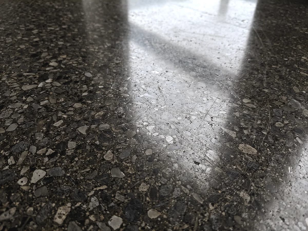 A fully polished concrete floor taken to a high gloss, the aggregate cut flat and flush with the paste and polished to the same sheen.