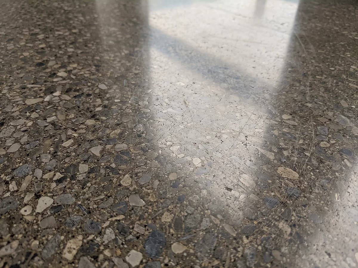 A fully polished concrete floor taken to a high gloss, the aggregate cut flat and flush with the paste and polished to the same sheen.