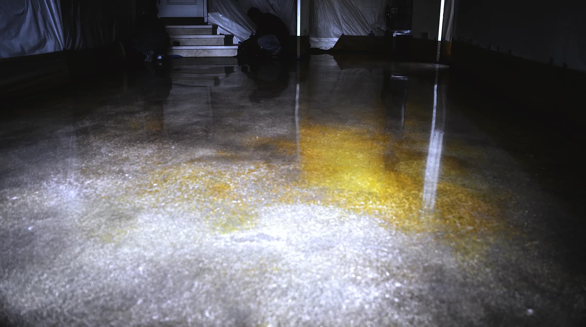 Installers coating a garage floor