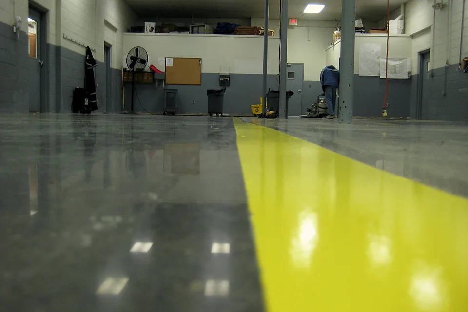 Fire department apparatus bays in Apopka after installation: finished floor with yellow safety striping