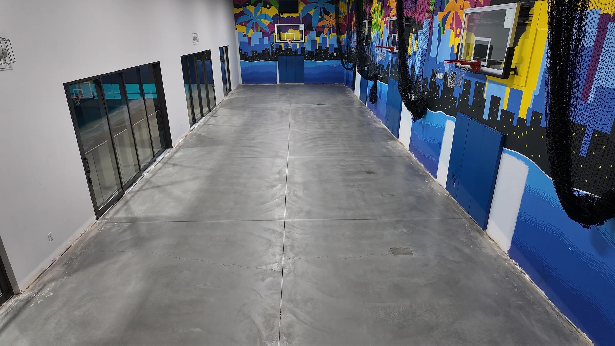 The same court before the coating went down: a bare grey concrete slab