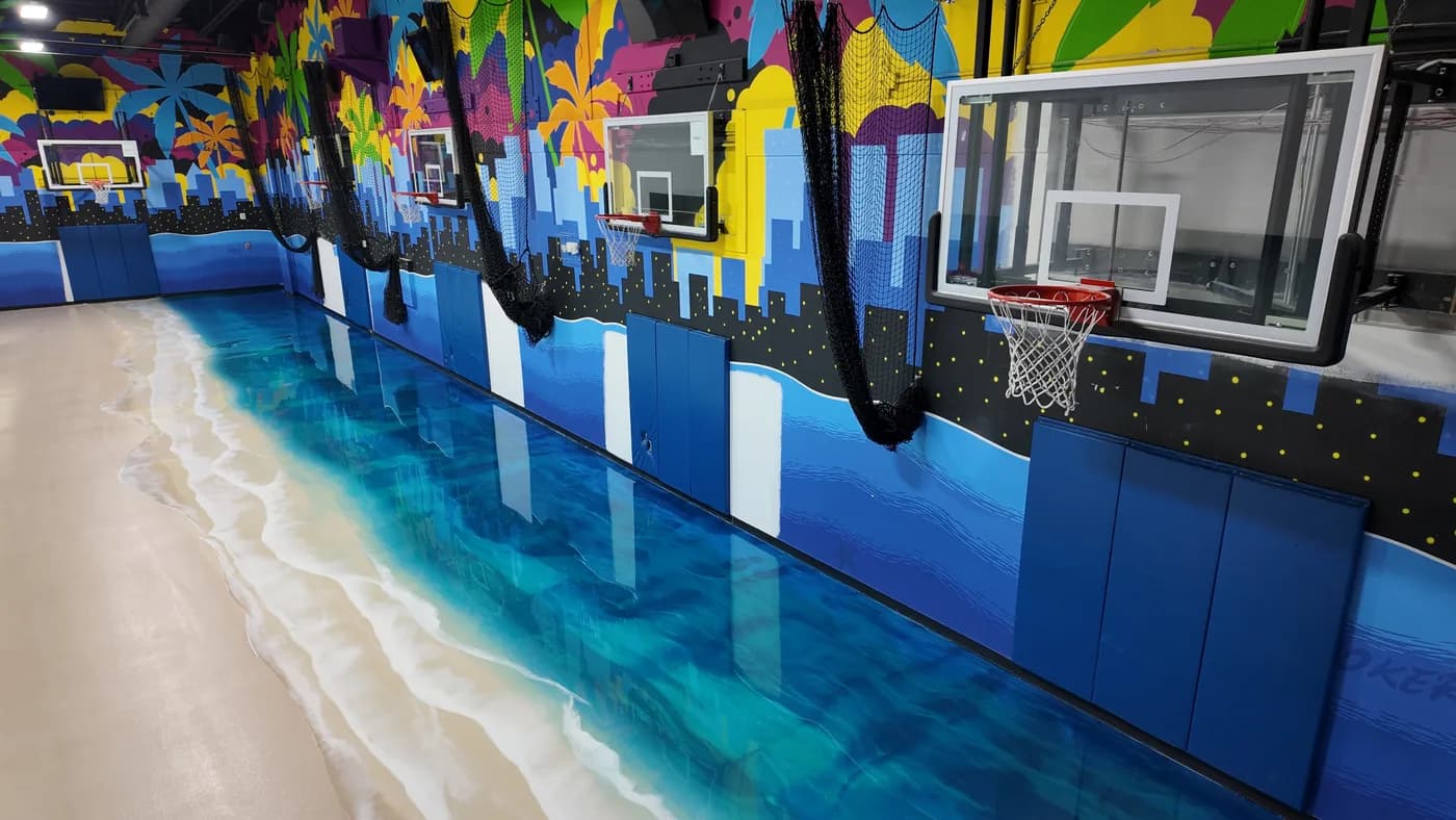 Ocean-blue metallic epoxy floor along an indoor court