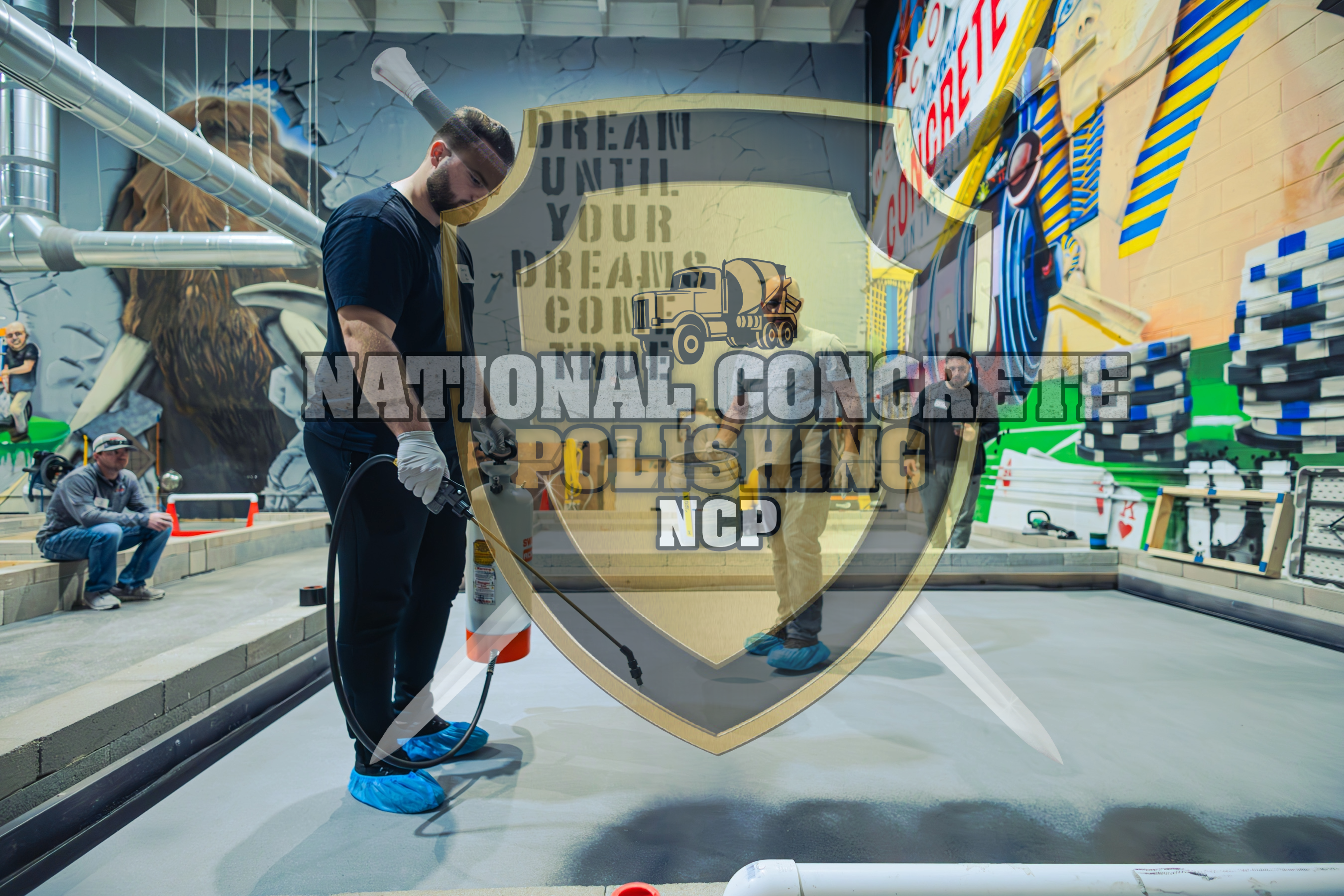 An epoxy resin contractor spraying a resinous coating solution on a warehouse training floor slab.